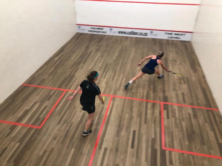 Amy Farreel and cornelie read playing squash